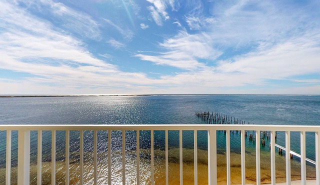 Cozy waterfront condo with pool, fitness area, balcony, & washer&dryer