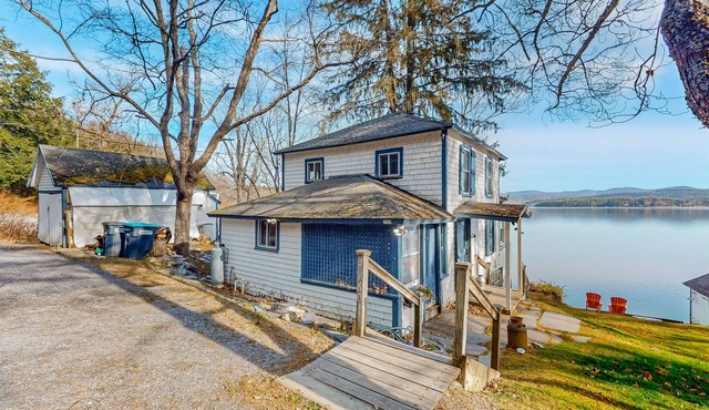 Dog-friendly cabin on the water with a sunroom, firepit, & full kitchen