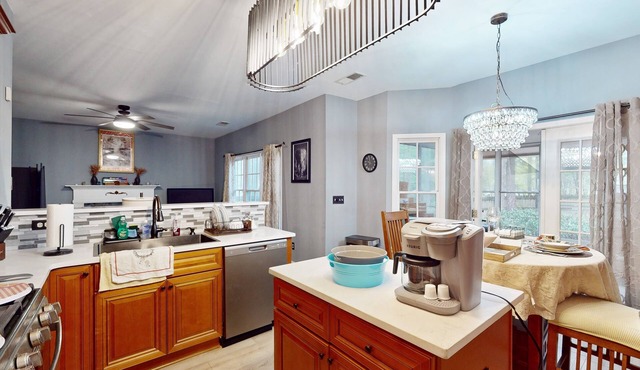 Dog-friendly home with pool access plus a sunroom, washer/dryer, & AC