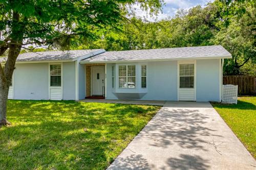 Dog-friendly home with fenced yard, patio, grill, & park across the street