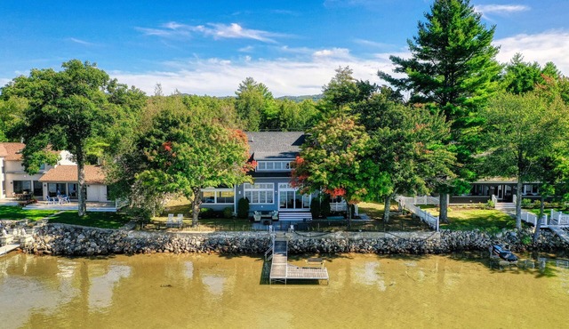 Dog-friendly lakefront home with lake views, firepit, dock, patio, & grill