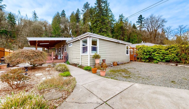 Dog-friendly riverfront home with patio, golf nearby, enclosed yard, & W/D