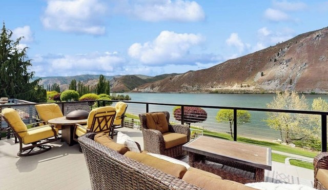 Dog-friendly waterfront home with pool, tennis courts, & large lawn