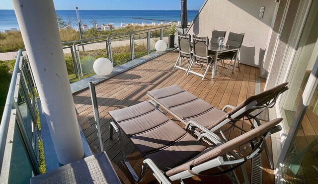Dream vacation apartment Ostseeresidenz 4 in Großenbrode. Inviting terrace with fantastic sea views and comfortable furniture to relax on. Exclusive wellness bathroom with sauna & feel-good corner bathtub