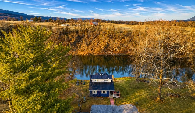 Dreamy riverfront home with sandy beach, hot tub, fire pit, kayaks & fishing