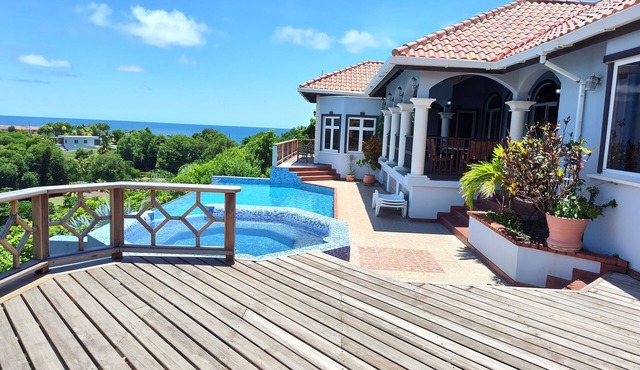 Enjoy the tropical breezes & coral reef views while sitting by the pool!