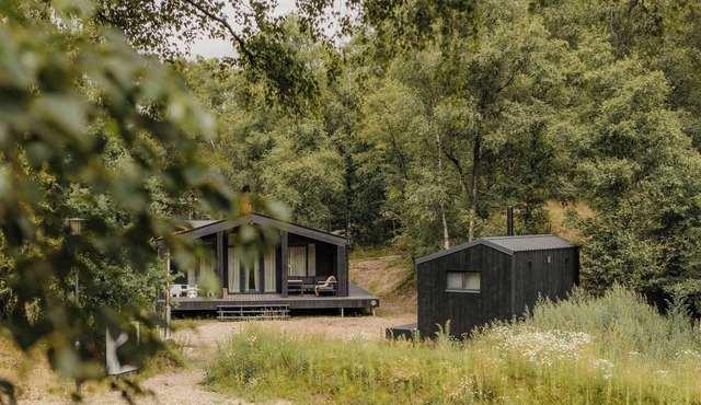 Enjoy a relaxing experience in an eco-friendly home with a hot tub, sauna, and sheltered location. The green roof provides a natural look and sustainable insulation. The private sauna offers the perfect opportunity to unwind and relax both body and m