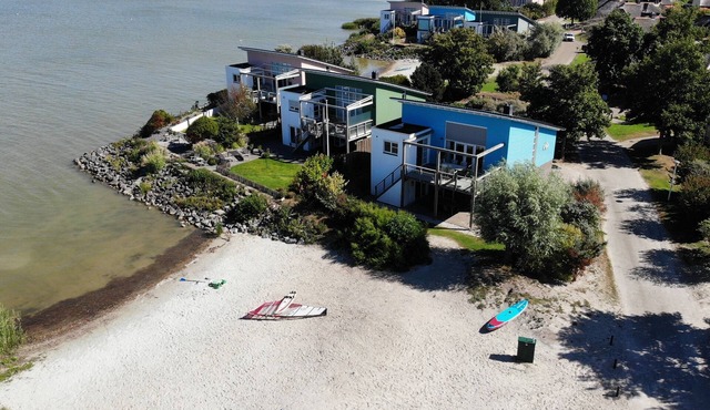 Exclusive 8-person Deluxe beach villa with panoramic views, freestanding bathtub, and steam shower cabin at Beach Resort Makkum on the IJsselmeer.