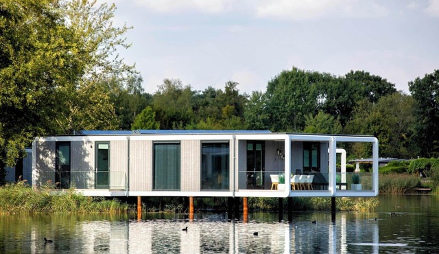 Exclusive water cube with wine climate cabinet three bathrooms and a terrace extending impressively over the water.
