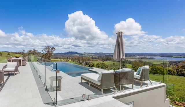 Expansive Hamptons home on acreage, with pool, spa, gym, tennis court & views.