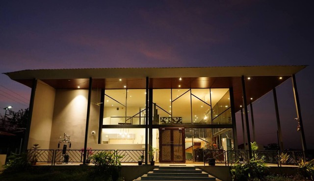 Glass House Surrounded By Hills