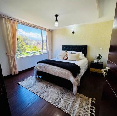 Habitación central con balcón, baño privado y parqueadero