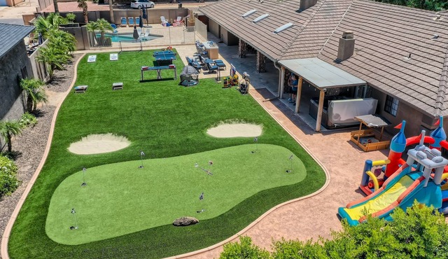 Heated pool, spa, games, putting green on spacious half acre private lot