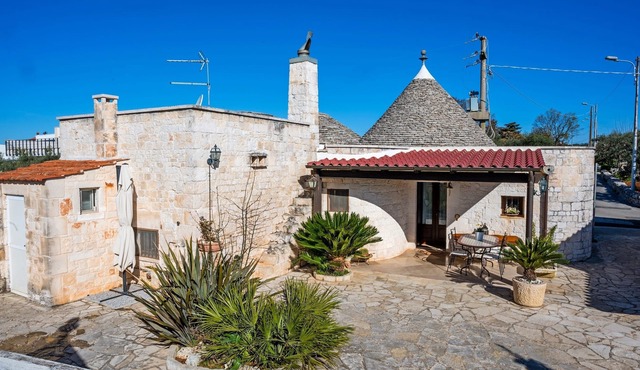 Historic trulli surrounded by ancient olive trees