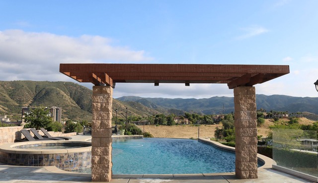 Home with infinity pool, hot tub, and mountain views. Pet-Friendly!