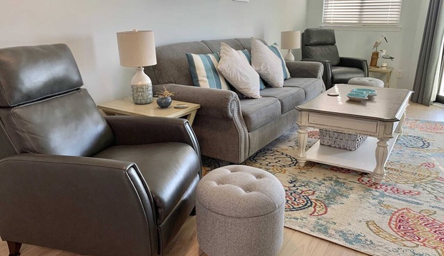 Inviting waterfront condo with marsh view, shared pool, balcony & central AC