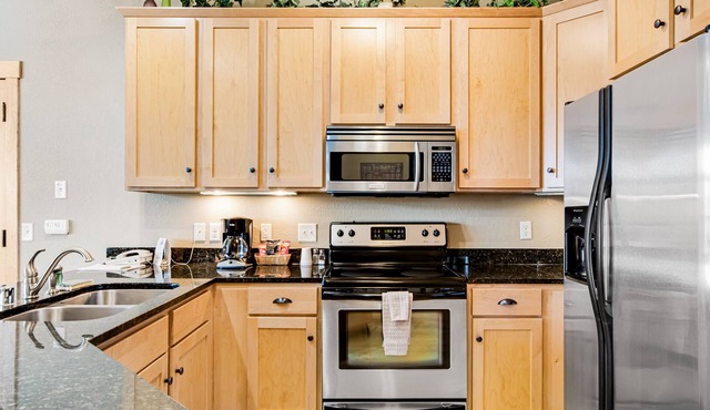 Lake-view condo with pool and hot tub access, jetted tub, firepit, and a balcony