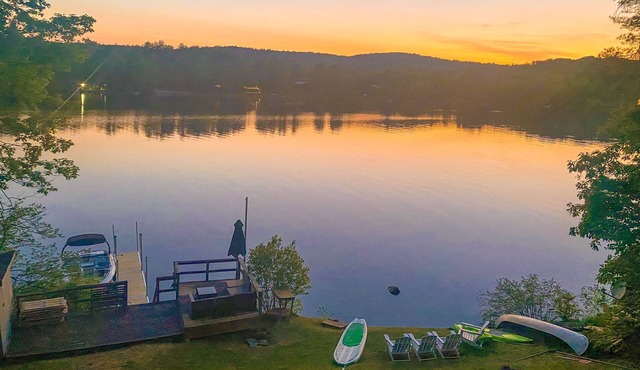 Lakefront home near ski resorts with water view, dock, deck, fireplaces, & W/D