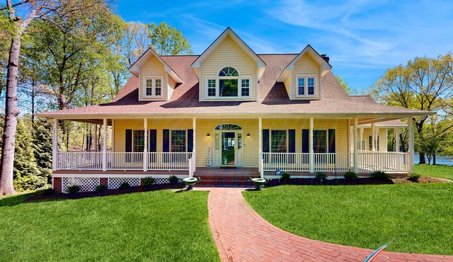 Lakefront home with private dock, kayaks, beach, badminton, firepit, & deck