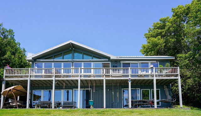 Lakefront home with fireplace, deck, patio, kayaks, and small beach