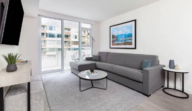 Level Seattle- Executive Two Bedroom Suite with separate office space, bedroom with king bed, full kitchen, living & dining area, private balcony, in-suite laundry, modern bathroom with Malin + Goetz amenities.