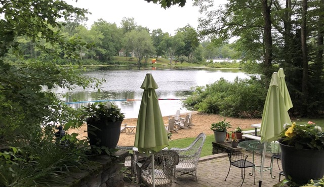 Light, airy, comfy, casual, wooded, lakefront home with private sandy beach