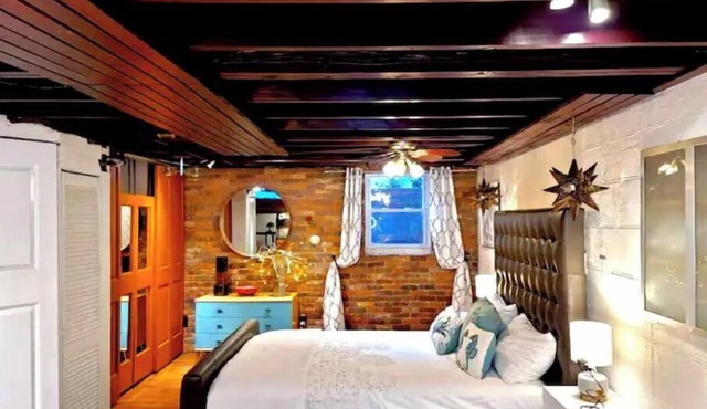 Live in this iconic East Side lower level apartment