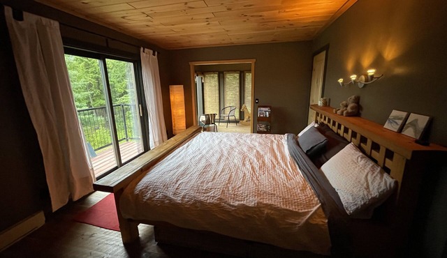 Loki Suite Private floor with a King size bed on the view side of the lodge.