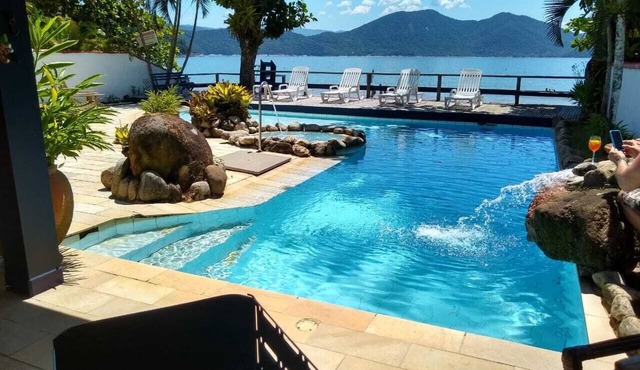 Luxurious beachfront house with swimming pool and terrace.