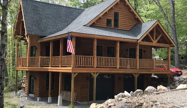 Luxury Log home steps from private beach in Meredith on Lake Winnipesaukee.