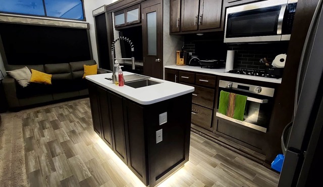 Luxury RV with full kitchen sleeps family of 6 inside fenced property