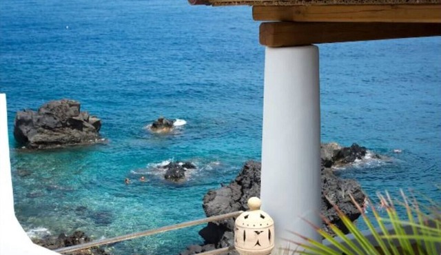 Marvel at sea & volcano views frm a chic Stromboli retreat steps from the beach.