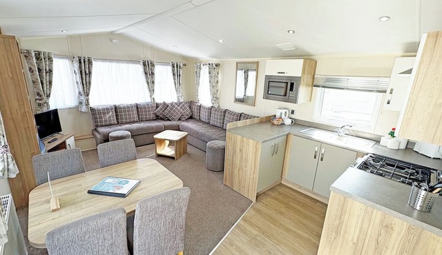 Modern and contemporary 12ft-wide caravan with one double and two twin.