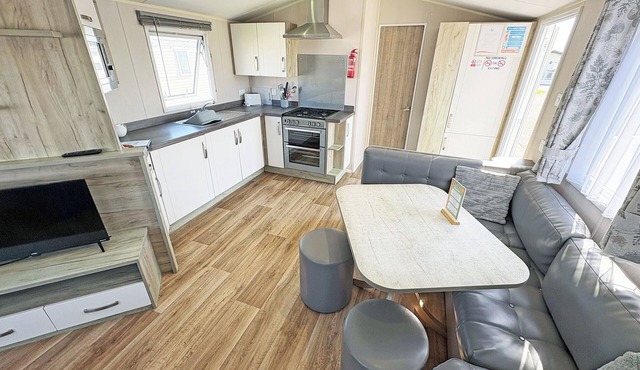 Modern and contemporary 12ft-wide caravan with one double and two twin.