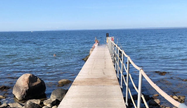 Modern and comfortable vacation apartment with shared outdoor pool, in the summery town of Båstad.