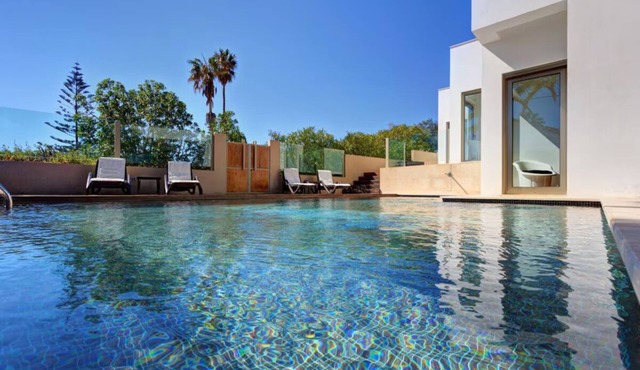Modern beachfront villa with heated pool and jacuzzi, ideal for families