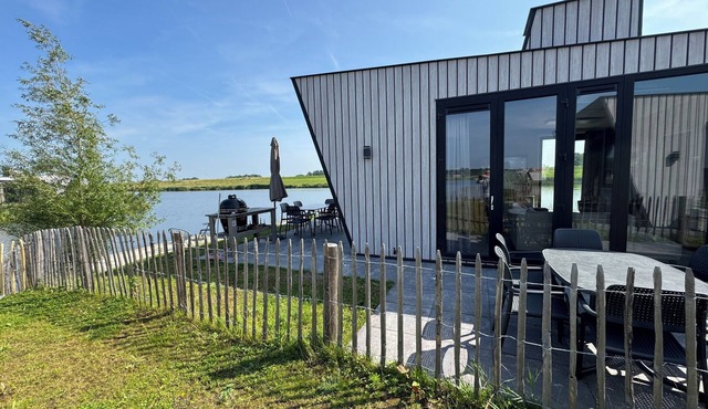 Modern chalet with exceptional lake and river views, private garden and fenced p