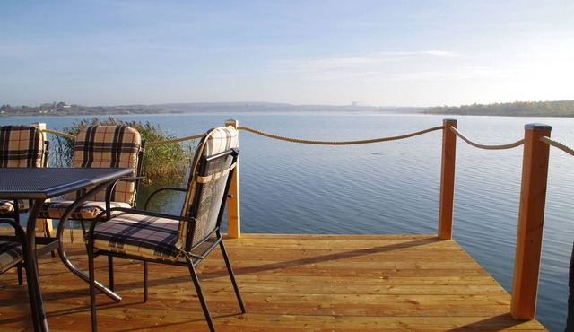 Modern holiday home directly in Hainer lake with boat