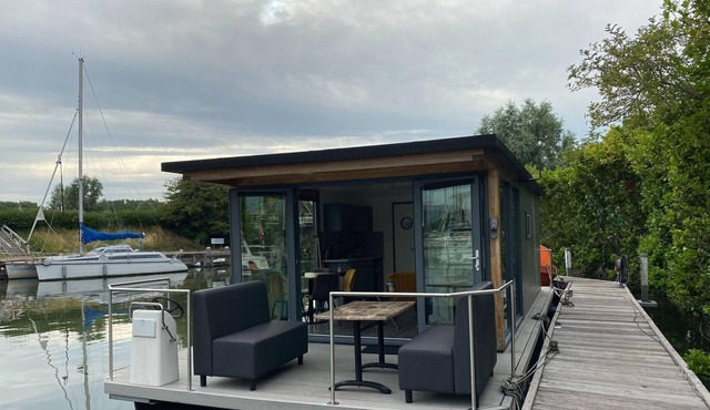 Modern house boat in Monnickendam with jetty