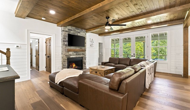 Modern lakefront retreat with private dock, game room, grill, & boat access