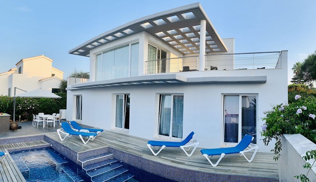 Modern luxury villa with pool and stunning sea views.