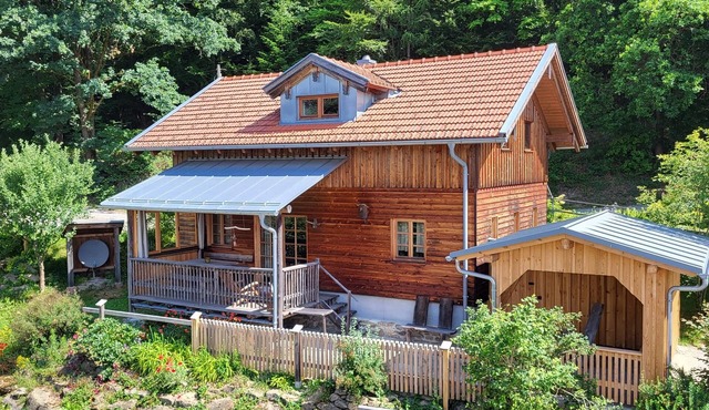 Modern mountain hut with large wooden veranda