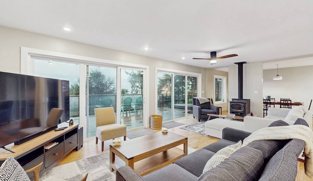 Modern ocean view home with private hot tub, big deck, and family-ready spaces
