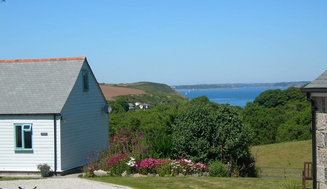 Nanteague - quirky luxury chalet-style cottage, sea views across a wooded valley