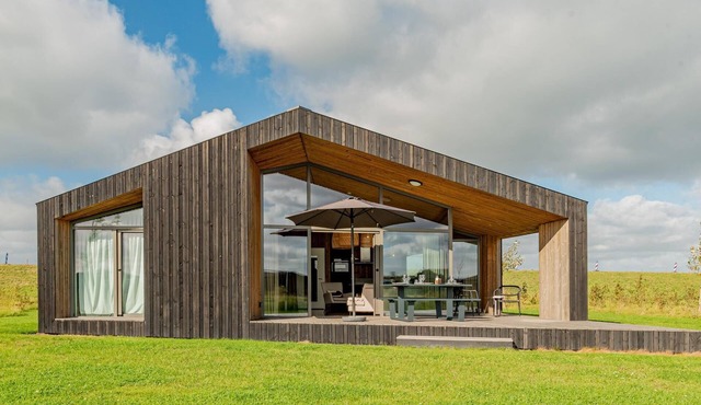 Nature house with wooden interior by the water
