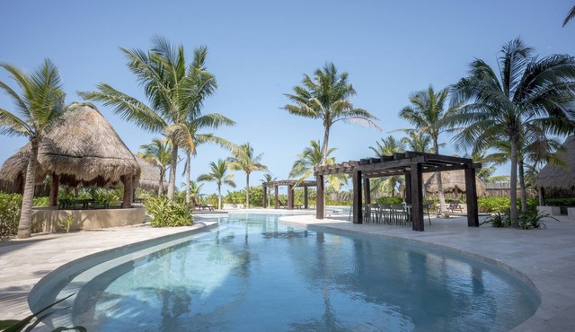 Oceanfront retreat with private balcony, outdoor pool, and stunning views