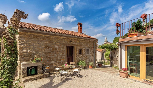 Old Istrian house under the rock in Ospnn