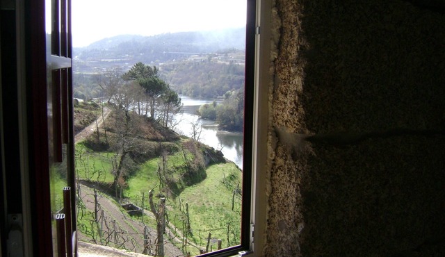 Old stone house with swimming pool and river.