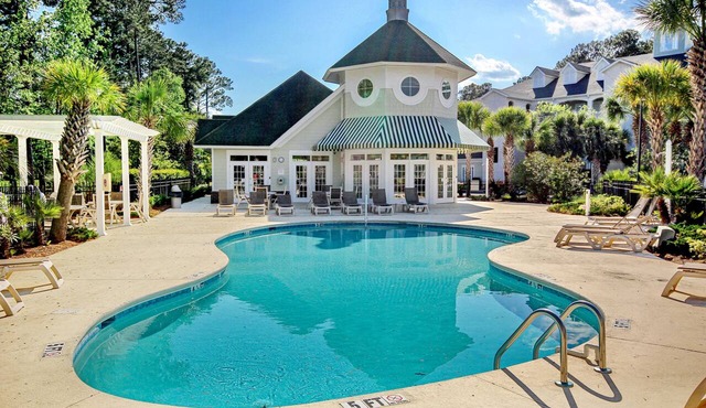 On-site golf condo with scenic balcony, pool access, AC, W/D, & full kitchen