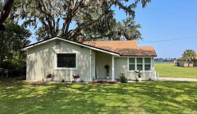 Peaceful Riverfront Cottage with a dock on 1.5 Acres.